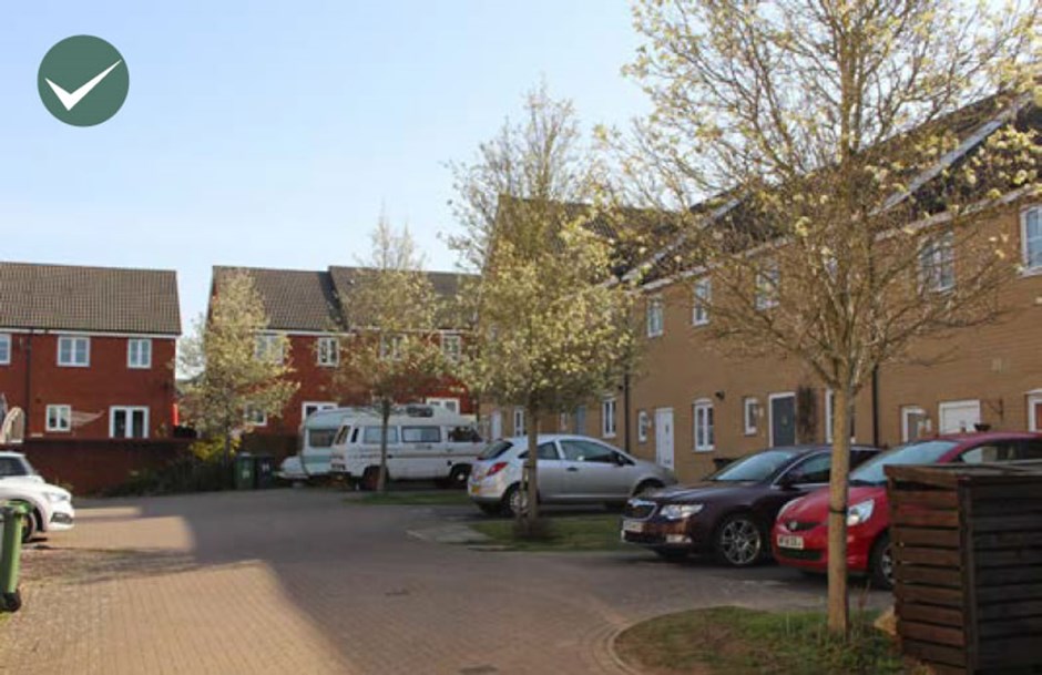 Parking court with trees and planting.