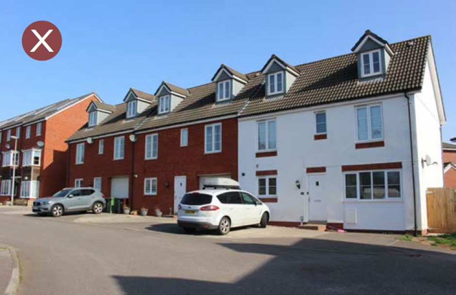 Parking in front of dwelling with no trees or planting to reduce the visual impact.