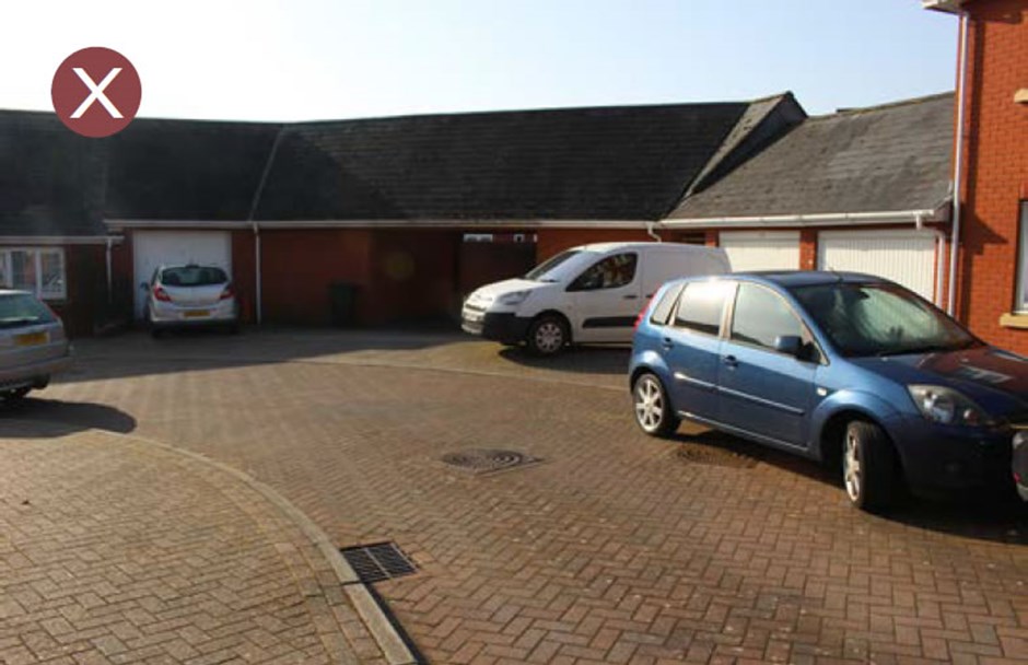 Large area of on-plot parking dominating the street scene and creating an intimidating environment for pedestrians.