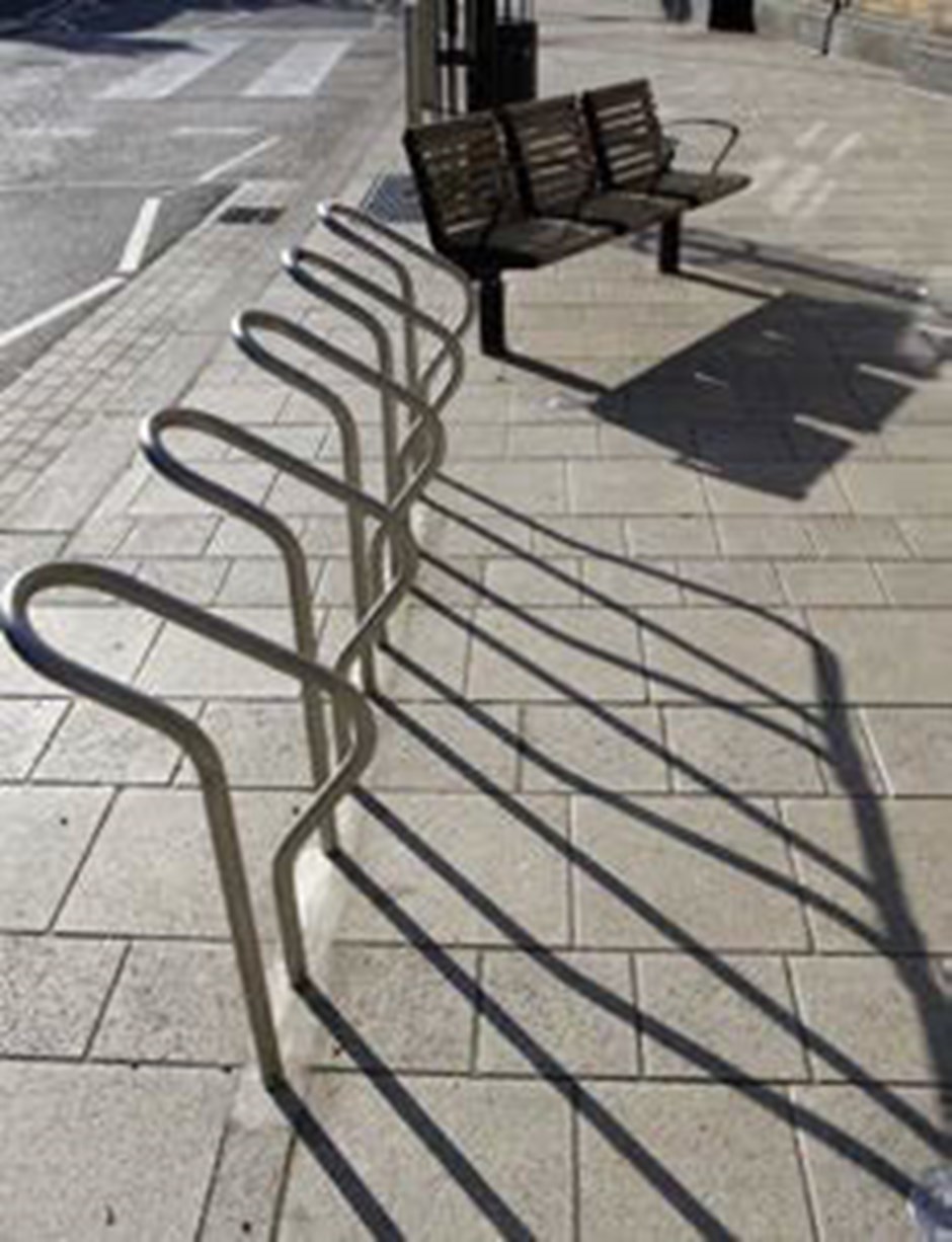 Clear dedicated cycle parking that is visible on the street.