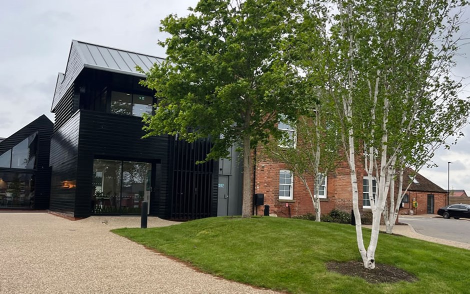 Existing barn converted and extended to provide a visitor centre at Houlton, Rugby alongside community uses and a cafe.