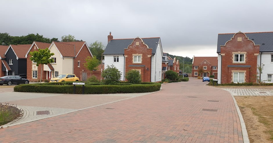 Transition from farmland character to parkland character marked by gatehouse inspired dwellings.